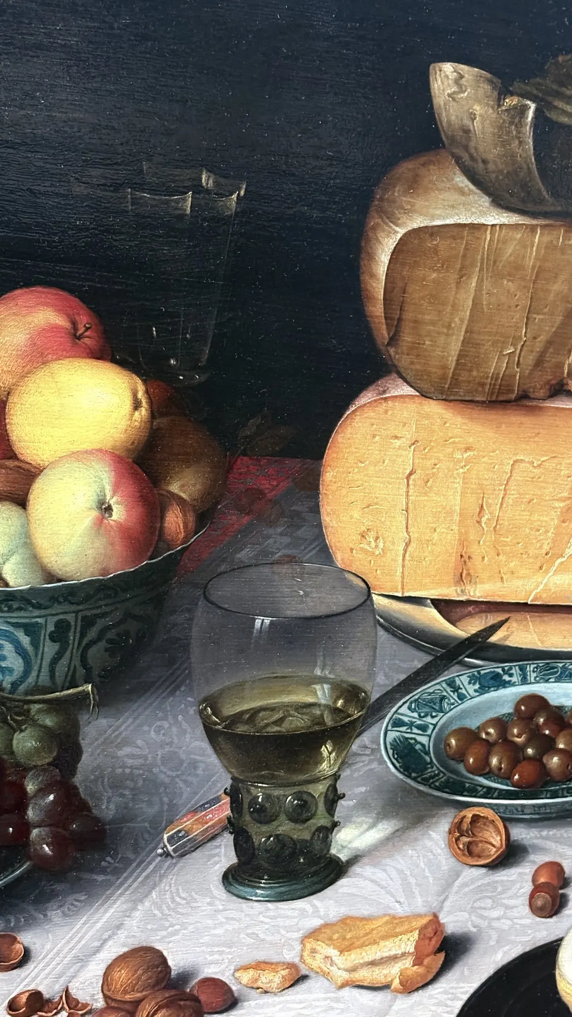 Still life with stacked cheeses, fruit and a roemer glass, Floris van Dijck