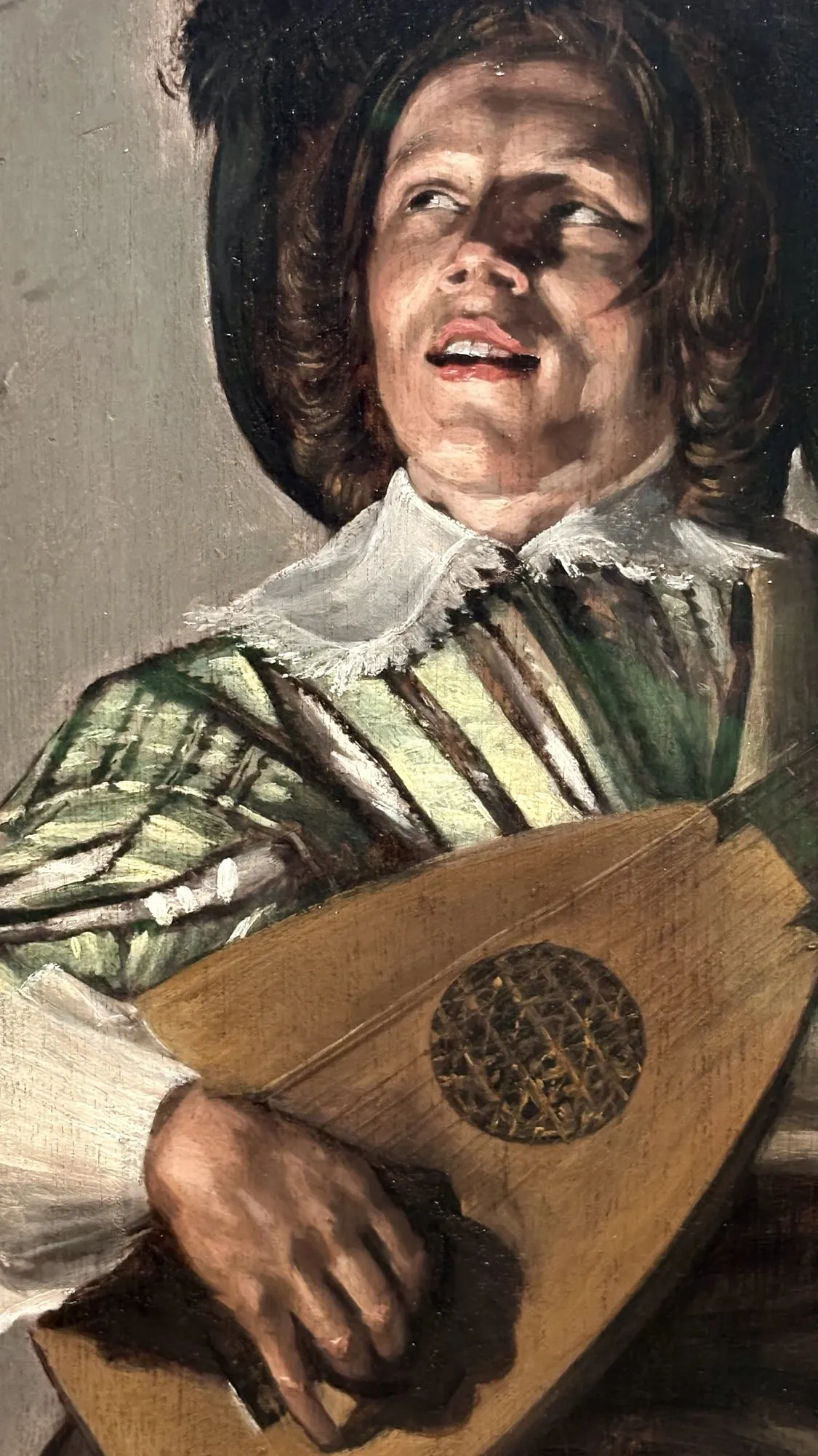 Lute player singing, mouth open and eyes raised, Dutch Golden Age painting