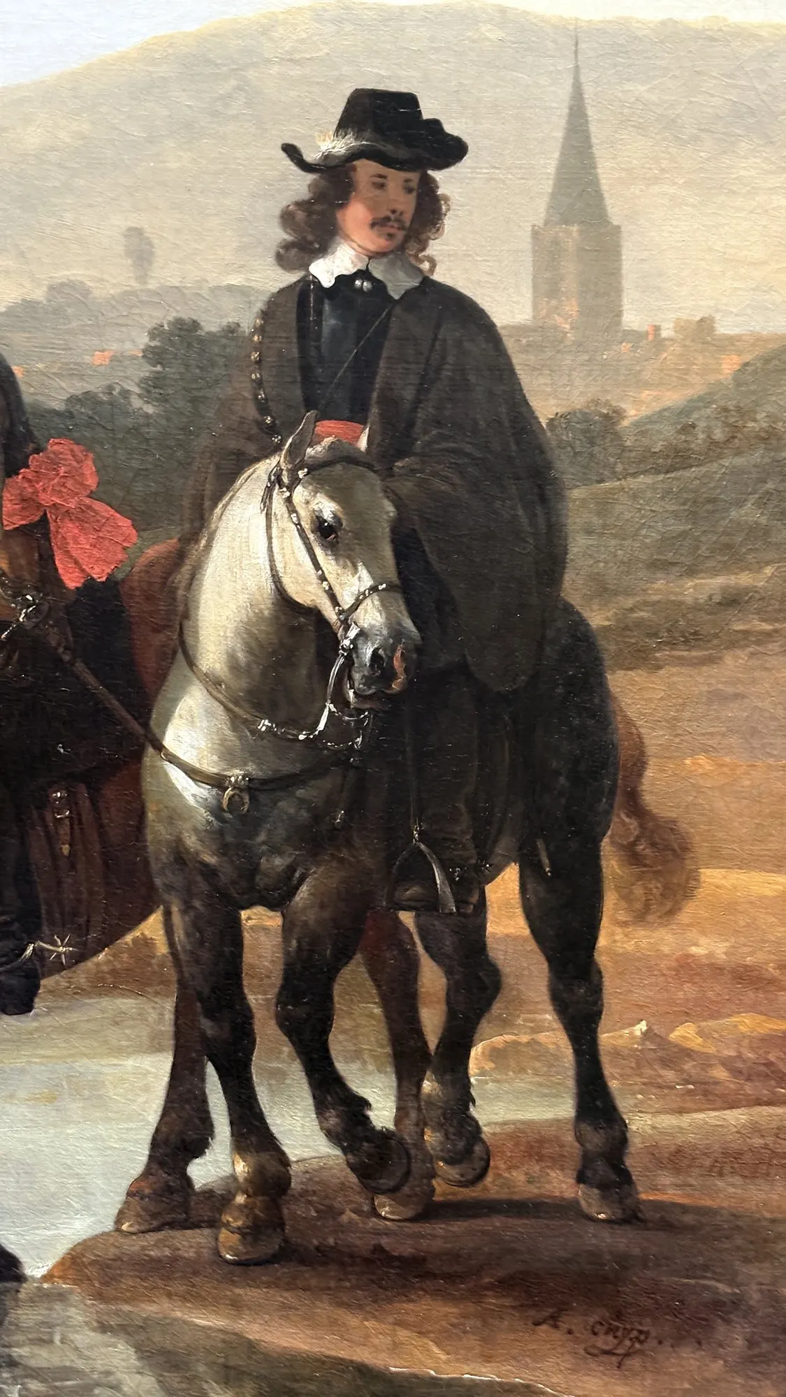 Rider in black on a grey horse before a village, canvas signed A. Cuyp