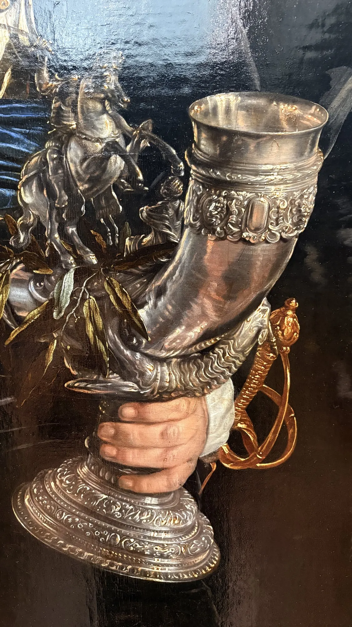 Silver-mounted drinking horn held in two hands, civic-guard banquet detail