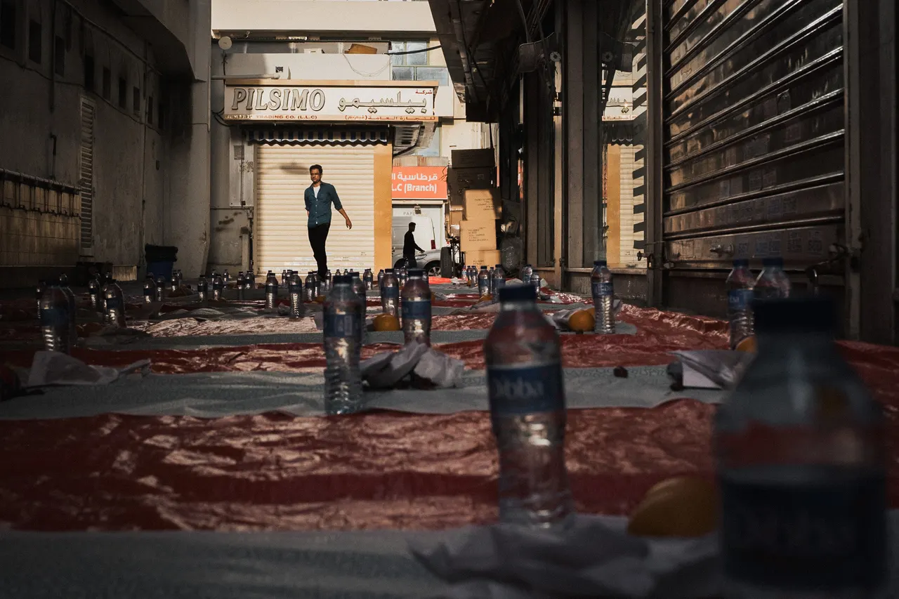 Iftar cloths in rows along a street of closed shutters